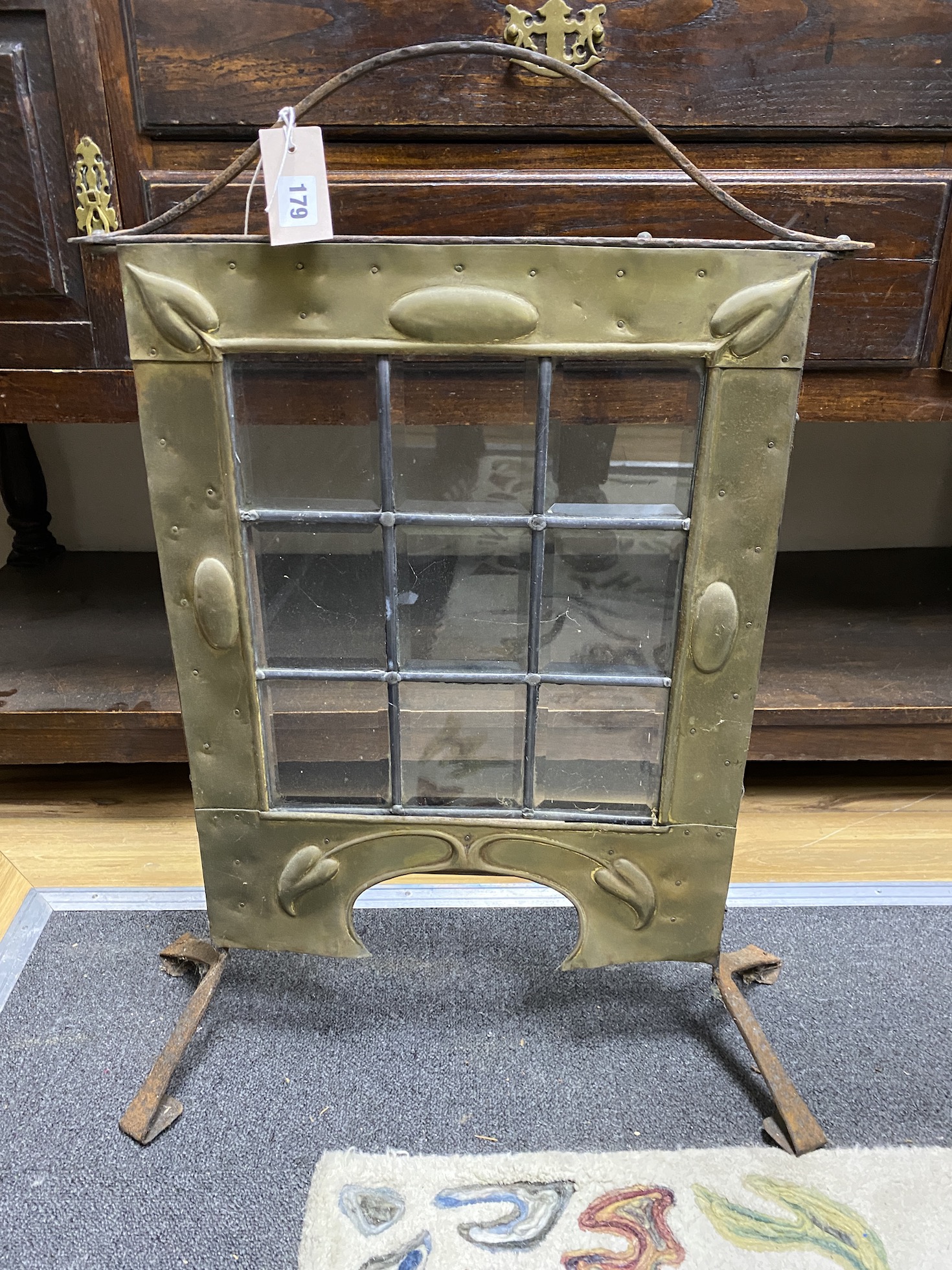 An Art Nouveau glazed brass and wrought iron firescreen, height 76cm